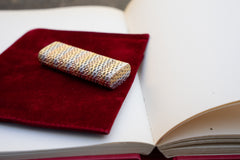 Cartier 18k tri-color gold lighter, side profile with cap closed showing continuous basket weave