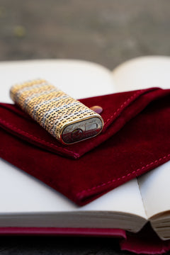 Cartier 18k tri-color gold lighter, portrait view showing basket weave body and base plate markings