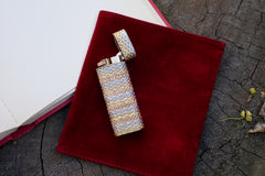 Cartier 18k tri-color gold lighter, close-up of tri-color basket weave texture