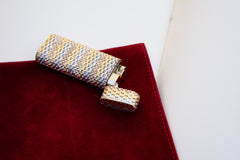Cartier 18k tri-color gold lighter, cap open at angle showing body and cap basket weave