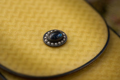 Cartier yellow guilloché enamel étui c.1920, sapphire cabochon clasp ringed with seed pearls, close up