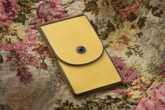 Cartier yellow guilloché enamel étui c.1920, étui closed, enamel front and flap with sapphire and pearl clasp