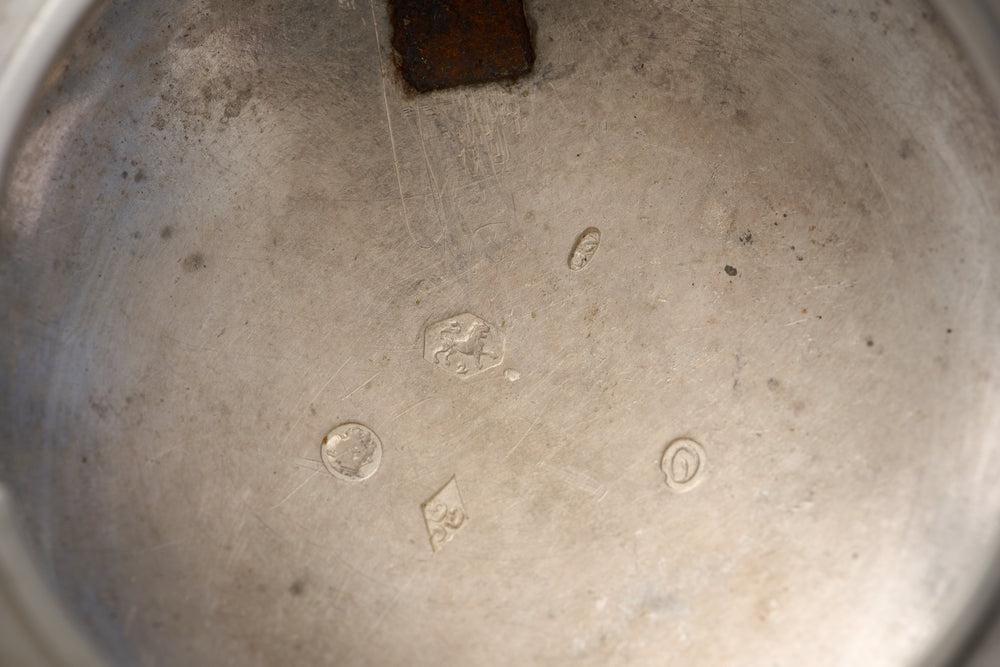 CG in a lozenge, crescent above