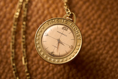 Gold Coin-Form Pendant Watch, 'Time Is Money' Bezel, c.1960, front view